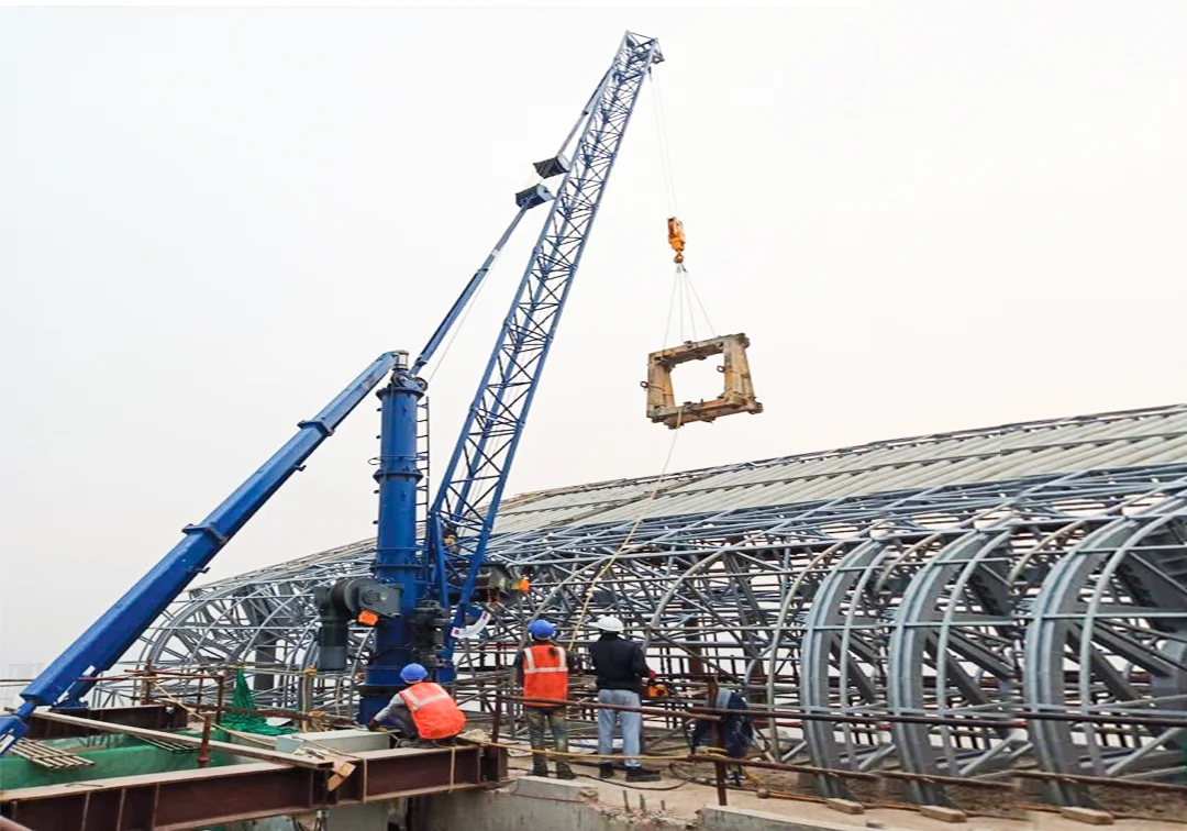Derrick crane lifting equipment from a rooftop site in India